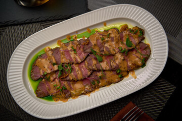 Succulent Roast Beef Served on a Decorative Platter with Rich Gravy and Fresh Garnish Ideal for Gourmet Dining Experiences