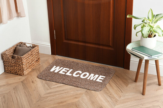 Welcome mat on floor near door in room