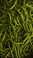 A pile of fresh green beans arranged in a market setting. Natural texture background of vegetables captured in close-up.
