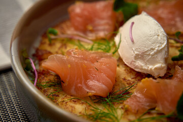 Indulgent Plate of Savory Delights Featuring Creamy Ingredients, Delicate Herbs, and Freshly Prepared Fish Garnished with a Touch of Excellence