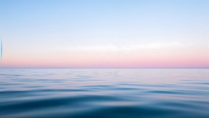 Obraz premium Calm Blue Ocean Water with Pink and Blue Sky at Sunset
