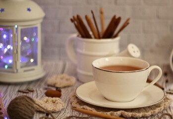 Knitting process, needles, cup of tea and different objects on the table beautiful photo