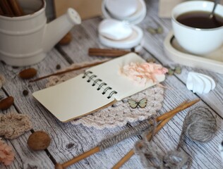 Cup of coffee, meringues, notepad diary and different woman things handmade art decor on wooden background table cozy photo 