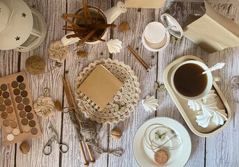 Cup of coffee, meringues, notepad diary and different woman things handmade art decor on wooden background table cozy photo