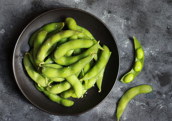 Green soybeans or Edamame in black plate. Healthy snack and side dish in Asian food