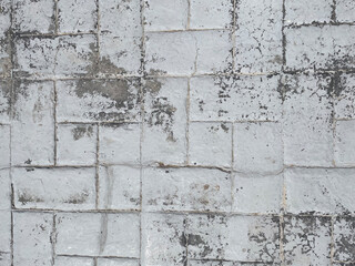 Old white brick wall with weathered texture and peeling paint. Rustic vintage surface ideal for backgrounds, design projects, architecture concepts, and grunge-style creative works.
