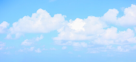 Background of blue sky with fluffy clouds