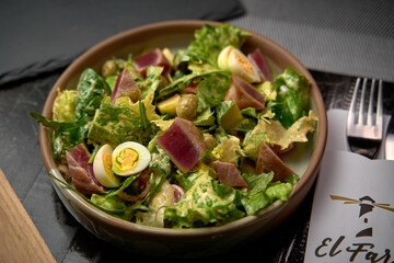 A Fresh and Vibrant Salad Featuring Crisp Greens, Tender Tuna, Creamy Eggs, and Flavorful Olives, Perfect for a Healthy Meal or Side Dish