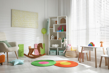 Stylish playroom with toys and furniture. Interior design