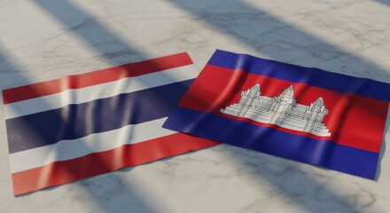 Flags of Thailand and Cambodia side-by-side on a marble surface representing cooperation and
