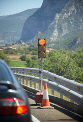 Portable traffic light installed on the side of the road for repair work