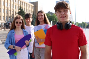 Group of teenagers walking together on city street