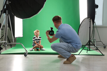Photographer working with model in professional photo studio