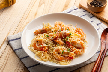 Garlic Butter Prawn Pasta.Angel hair spaghetti with shrimp garlic and butter topped with parmesan cheese in white plate.