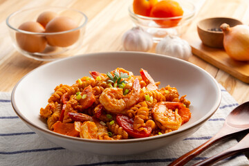 Spiral pasta and shrimp,Stir Fried Macaroni with prawn tomatoes egg and Tomato Sauce in white plate.Thai Italian fusion food.