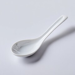 A simple white ceramic spoon, isolated on a pure white background. Kitchenware, minimalist.