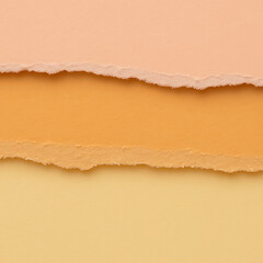 Fototapeta premium Creative pastel torn paper background with layered textures in peach, orange, and yellow shades for design and art projects