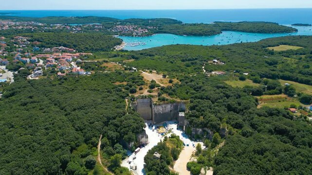 Ancient Roman quarry Cave Romane near Pula, Croatia &ndash; historic stone site surrounded by forest, dramatic rock formations