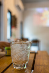A glass of water with ice on table. Refreshing glass of water