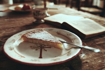 Slice of Cake, Antique Plate, and Open Book on Weathered Wooden Table, Vintage Style, Warm Tone