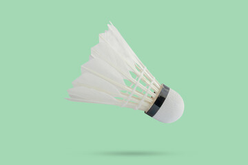 Badminton shuttlecock floating on green background