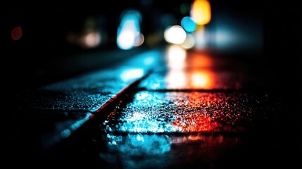 Dramatic blue and red light reflections on wet pavement in an atmospheric urban night scene.