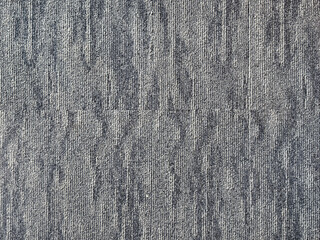 Close up of blue carpet tiles in random and abstract pattern. Combination shades of blue with grunge and dirt texture. Suitable for flooring and wall covering. Seamless background texture