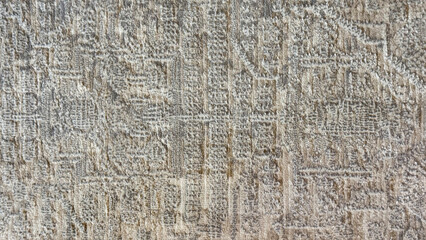 Close up of 3D textured ethnic carpet or rug. Random engraving of ethnic or tribal pattern on a wall, or fabric, or carpet. Suitable for flooring and upholstery. Seamless background texture.