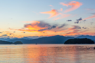 a sunset view of the sea with a yacht