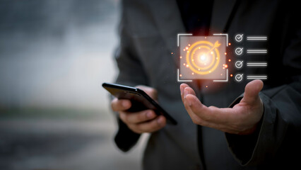 Business planning concept and strategic goal setting and with a businessman pointing at a target icon and checklist. Ideal for success, productivity, project execution and leadership content.