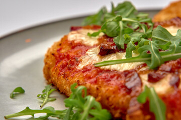 Crispy Fried Dish Topped with Fresh Greens and Rich Sauces for a Flavorful Culinary Experience