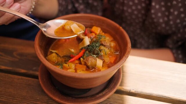 Savory lagman is presented with chunks of beef colorful vegetables and a touch of chili pepper showcasing a hearty dish perfect for a warm meal