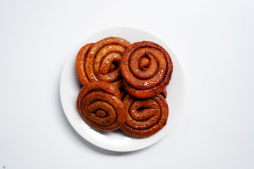 Sweet Spiral Candy Treats in White Plate on Simple White Background