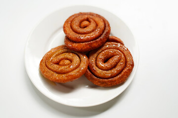Spiral Crunchy Candies on White Plate Isolated on White Background