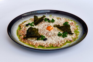 A Culinary Marvel Featuring Fresh Ingredients, with a Central Egg Yolk Surrounded by Delicate Textures and Flavorful Garnishes on a Black Plate