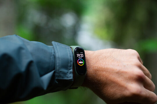 fitness tracker on a man's hand in the forest near river