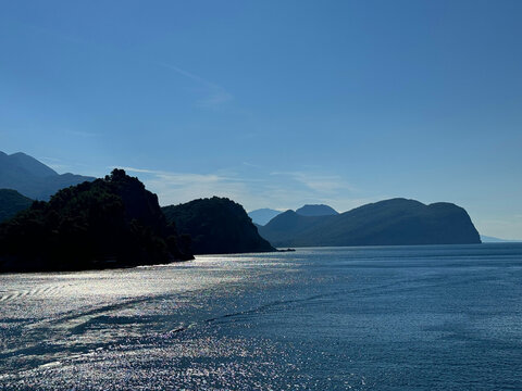 Calm glittering sea and blue sunny sky.