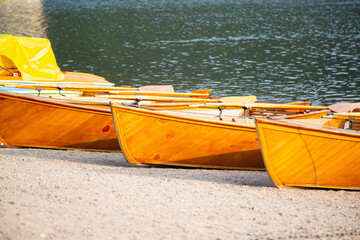 wooden boats on the shore at the lake resort