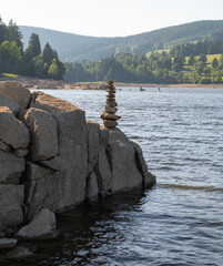 pyramid of stones on the lake coast