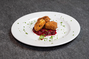 Crispy Fried Camembert Cheese with Sweet Cranberry Sauce on White Plate. Gourmet Appetizer Dish