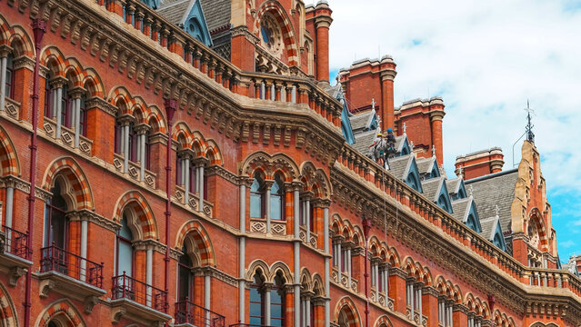 Victorian Gothic architecture with red bricks and clock tower in London city