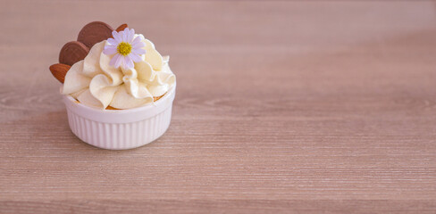  small piece of cake in a little cup looks delicious and has beautiful colors.