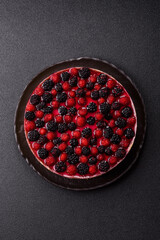 Pie, cheesecake with raspberries and blackberries, mascarpone cheese. Piece of cheesecake