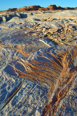 Sandstone Rock Strata Patterns - The setting sun hi-lights  sandstone layering on the shores of Lake Powell a reservoir on the Colorado River in Utah and Arizona, United States
