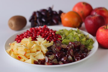 Fruit Platter. Vibrant fruit plate with pomegranate seeds, diced kiwi, grapes and apples