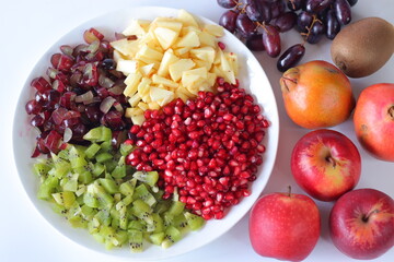 Fruit Platter. Vibrant fruit plate with pomegranate seeds, diced kiwi, grapes and apples