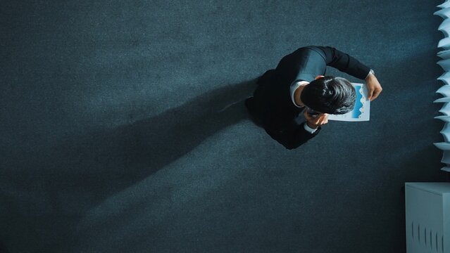 Top view of smart male leader calling phone while project manager give financial document. Businessman talking to investor to brainstorm idea by phone while looking at data analysis. Directorate.