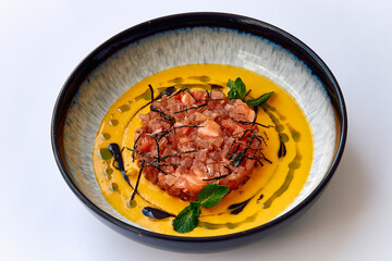 A Colorful Plate of Gourmet Culinary Art Featuring Fresh Tuna and Vibrant Mango Sauce with Herbs and Garnishes for an Exquisite Dining Experience