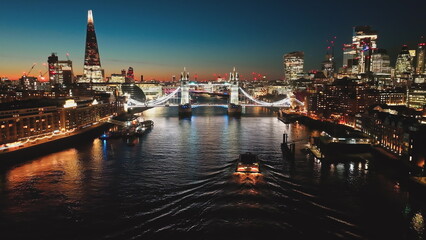 United Kingdom, London: Breathtaking aerial view of London at night, illuminated Tower Bridge, The...
