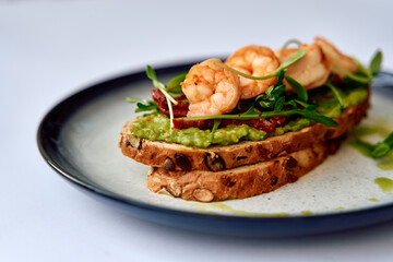 Delicious Gourmet Toast Topped with Succulent Shrimp, Fresh Greens, and Savory Ingredients on a Rustic Bread Base